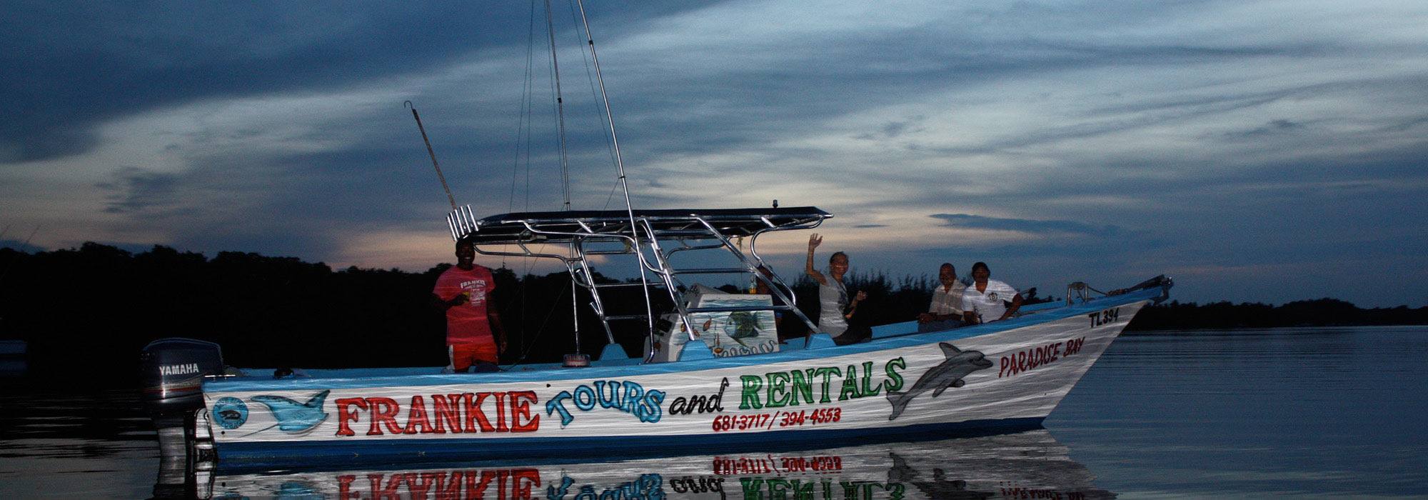 The Frankie Tours boat on still water at dusk