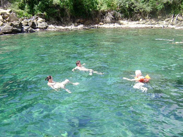 Guests swimming in clear turquoise water